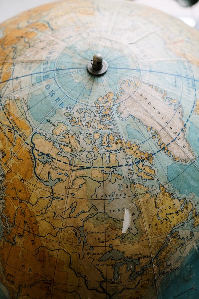 Detailed close-up of a vintage globe showing the Northern Hemisphere, highlighting Arctic regions.